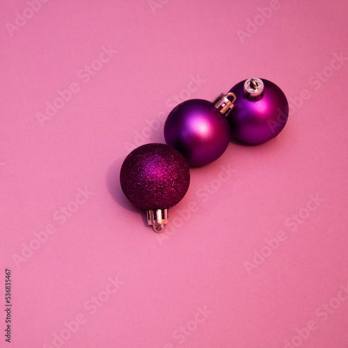 New Year's and Christmas decorative balls on pink background. photo