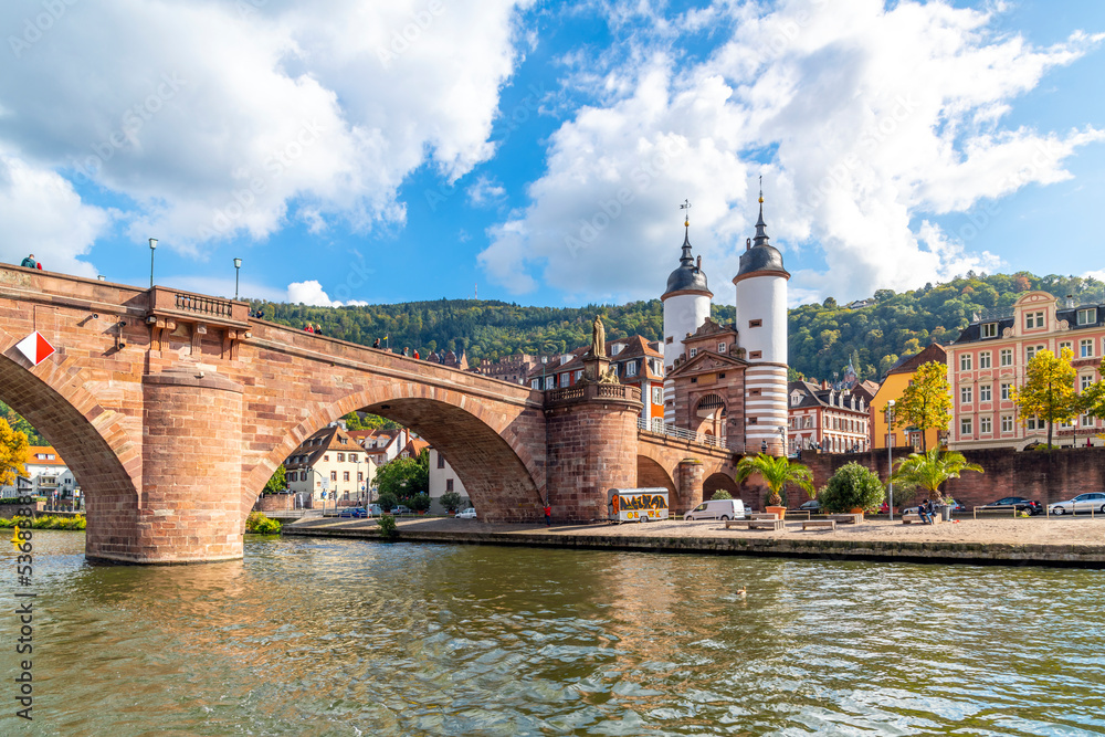 Fototapeta premium The Karl Theodor Bridge, commonly knows as the Old Bridge, and the Bridge Gate along the Neckar River in the Bavarian city of Heidelberg, Germany.