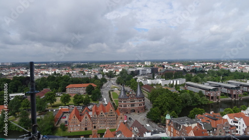 Lübeck, sky, clouds, buildings, trees and the holstentor at germany