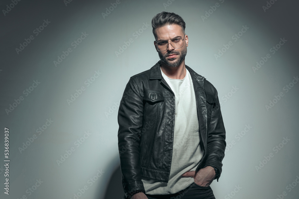 Fototapeta premium fashion guy posing with attiude, putting a hand in pocket
