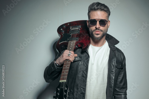 rocker wearing a black leather jacket and sunglasses photo