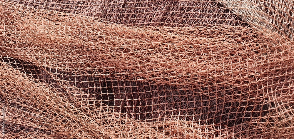 Fishing nets for catching fish in the sea and ocean. Fishing nets on a  ship. Texture of fishing nets. Stock Photo