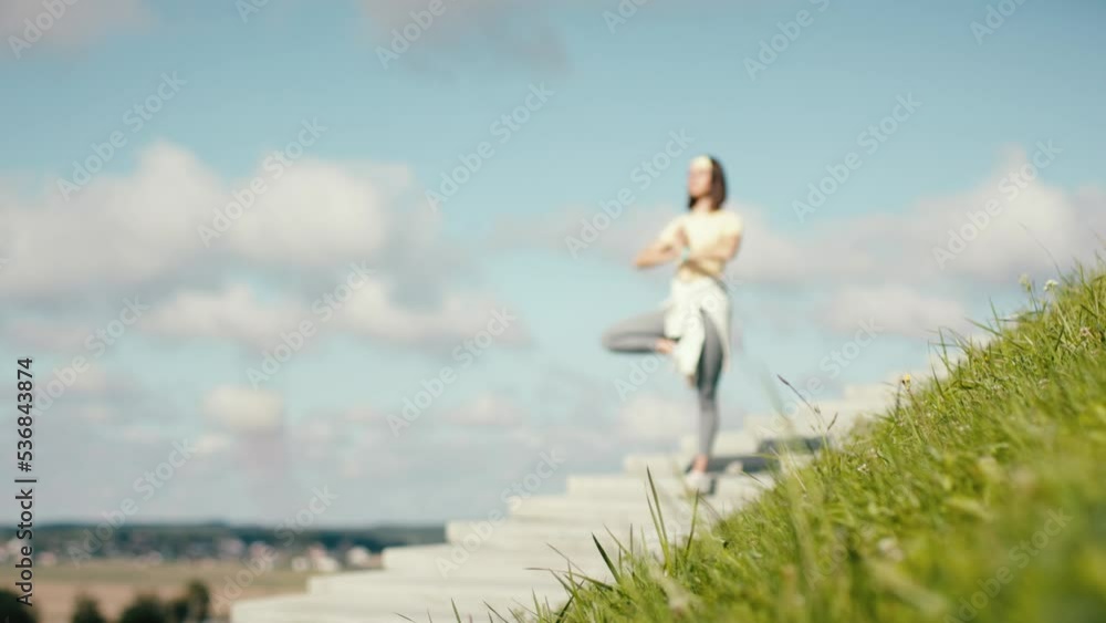 Fitness young adult woman making yoga and pilates pose on stairs. Female workout on sky background. Amazing sky view training. Stairs to haven. Fitness young adult woman making yoga and pilates pose on stairs. Female workout on sky background. Amazing sky view training. Stairs to haven.