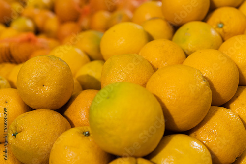 Fresh oranges in the supermarket. Vegetables and fruits exposed for the consumer to choose