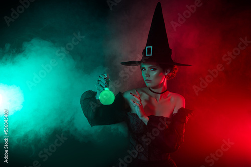 Photo of creepy fear sorcerer lady alchemist make toxic love potion isolated on gradient shine mist background