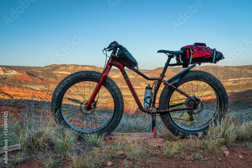 fat mountain bike with a frame and trunk bag during biking trip at foothills of Colorado, fall scenery in Red Mountain Open Space
