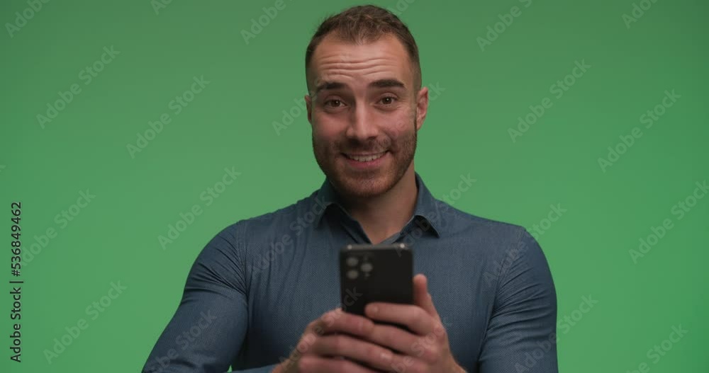 casual man reading good news on his phone and giving a big like casual man reading good news on his phone and giving a big like