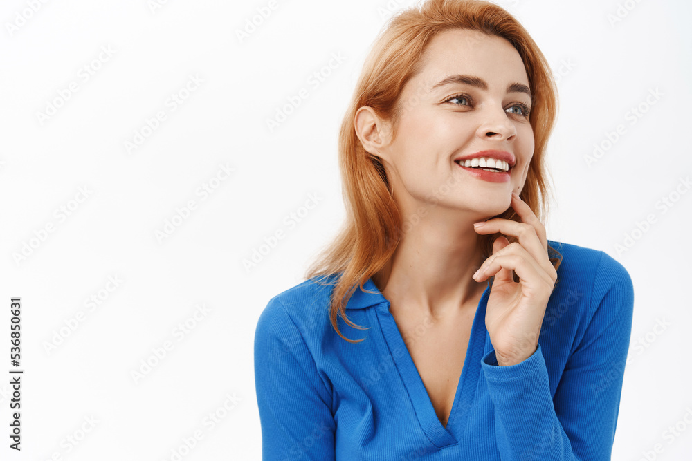 Close up portrait of natural beauty woman, laughing and smiling, she has clear glowing skin, nude makeup, white smile, stands over white background Close up portrait of natural beauty woman, laughing and smiling, she has clear glowing skin, nude makeup, white smile, stands over white background