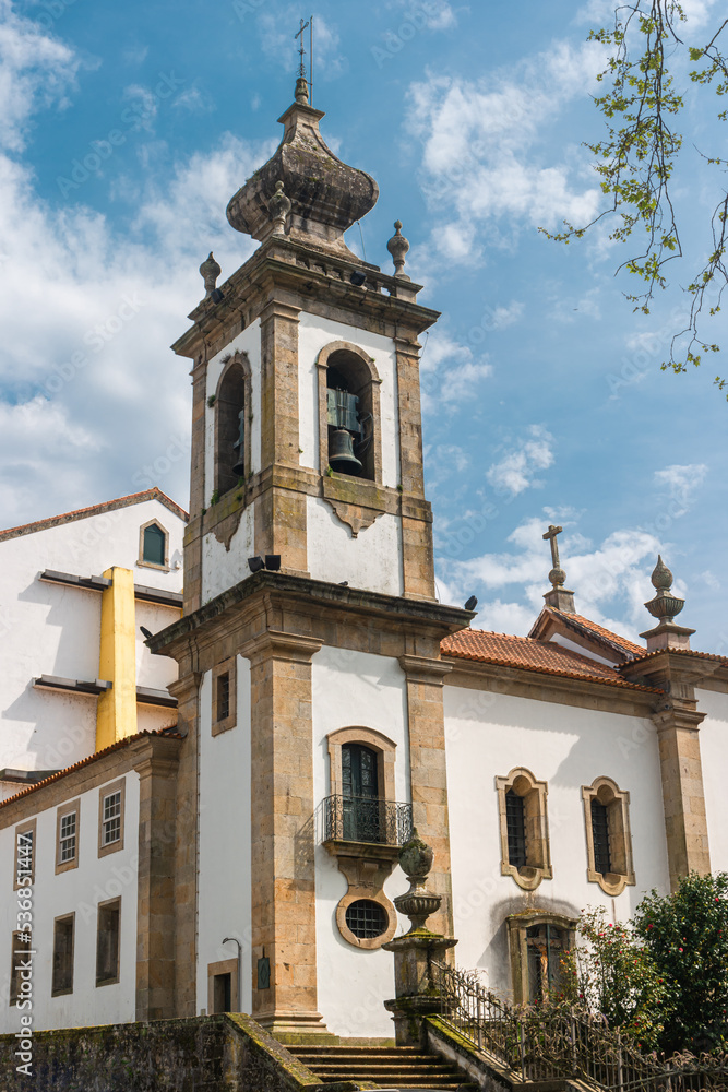 Fototapeta premium Park bench in river side view in nature landscape, Ponte de Lima, Portugal