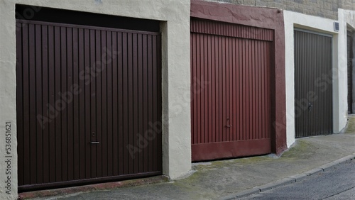 sidewalk with metal garage doors