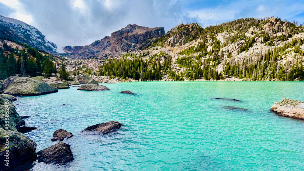 Lake Haiyaha - Rare blue Alpine lake, Rocky Mountain National Park, Colorado with snow and pine trees and mountain Lake Haiyaha - Rare blue Alpine lake, Rocky Mountain National Park, Colorado with snow and pine trees and mountain