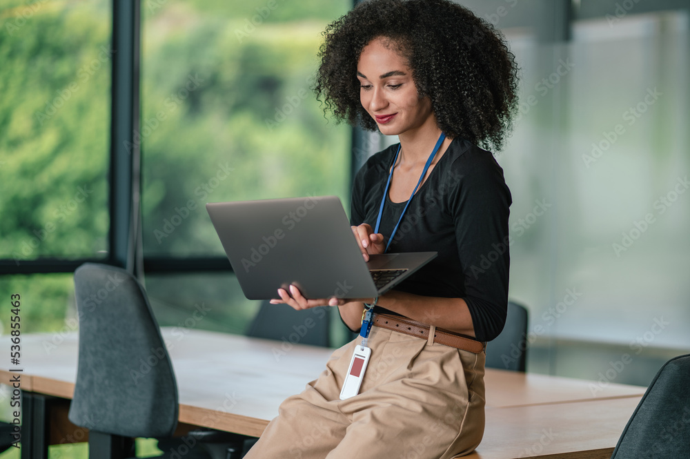 Pretty elegant curly-haired businesswoman in the office Pretty elegant curly-haired businesswoman in the office