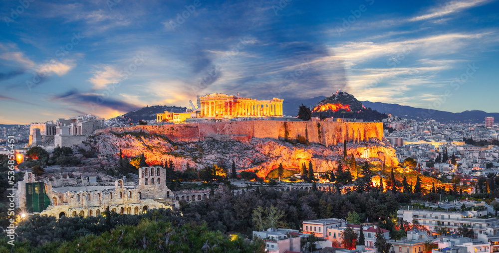 Night view at historical center of Athens, Greece. Artistic postproduction with dramatic sky over old ancient European city, touristic iconic destination. View at Acropolis building and Agora mountain