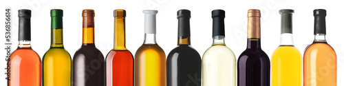 Set of bottles with different kinds of wine on white background