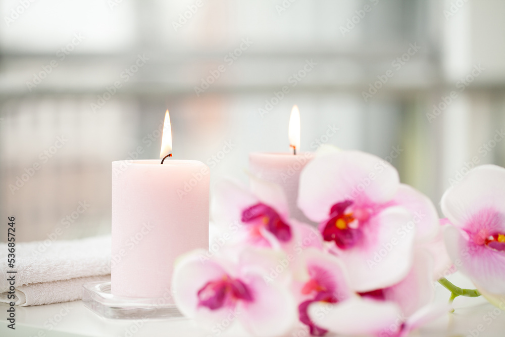 Orchids and burning aromatic candles on spa salon Orchids and burning aromatic candles on spa salon