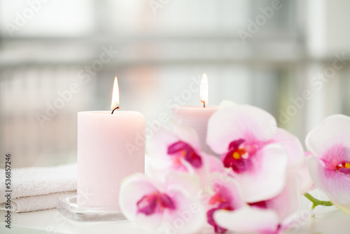 Orchids and burning aromatic candles on spa salon