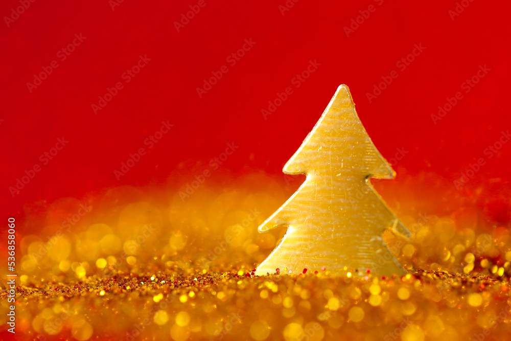 Christmas wallpaper in gold and red colors.Christmas tree mini in gold glitter on a on a red background .Winter holidays wallpaper Christmas wallpaper in gold and red colors.Christmas tree mini in gold glitter on a on a red background .Winter holidays wallpaper