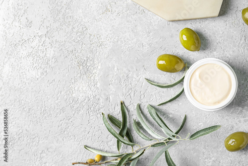 Jar of natural olive cream on light background