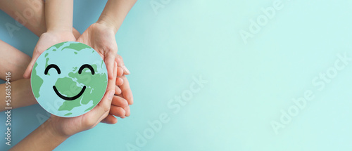 Hands holding earth with smile face, save planet, earth day, environment day, happy world, csr social responsibility, sustainable living concept