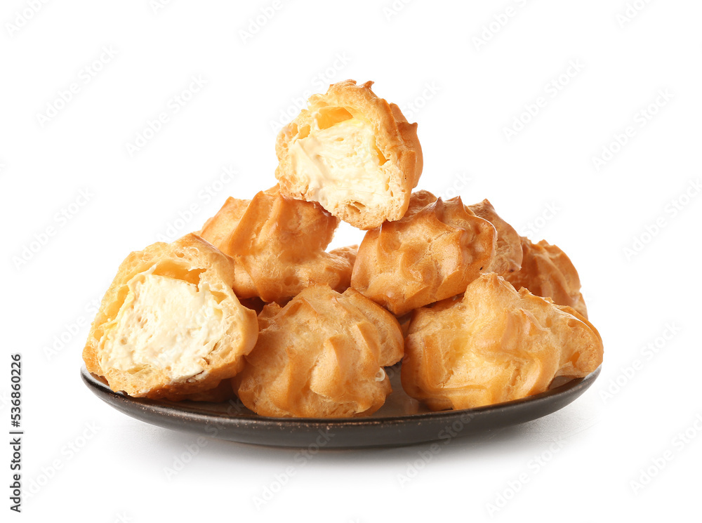 Plate with tasty round eclairs on white background Plate with tasty round eclairs on white background