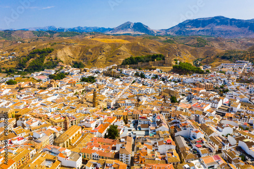 Scenic view from drone of center of Spanish city of Antequera overlooking ancient fortified Castle and Royal Collegiate church of San Sebastian, Andalusia, Spain