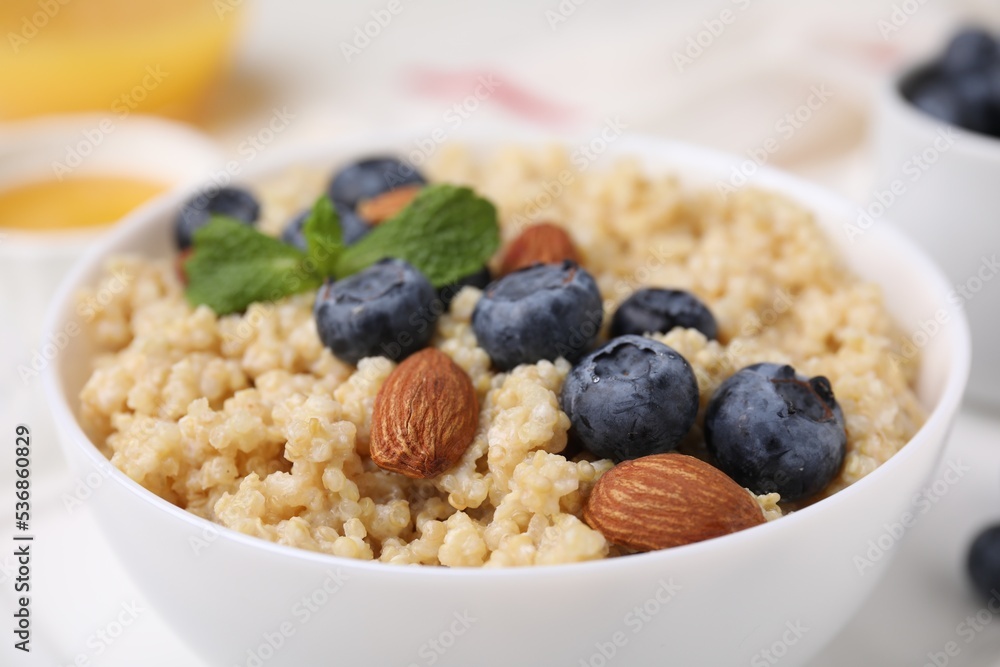 Bowl of delicious cooked quinoa with almonds and blueberries, closeup Bowl of delicious cooked quinoa with almonds and blueberries, closeup