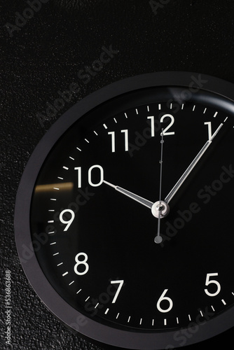 black modern clock hanging on a black wall (ID: 536863688)