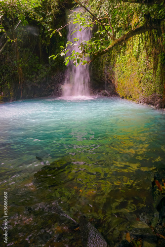 Curug Cipondok of Subang west Java Indonesia. Jungle waterfall cascade in tropical rainforest with rock and turquoise blue pond. 