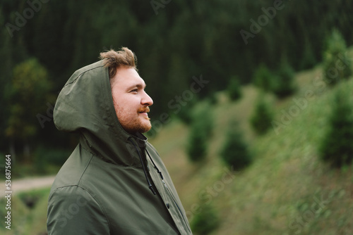 Portrait of Young happy male in the forest. Wellness concept and holistic rest. Portrait of a traveler