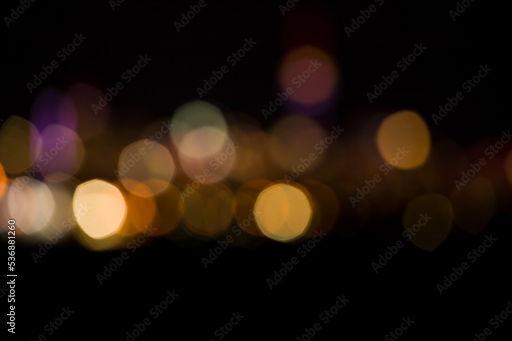 Fototapeta premium Black and yellow bokeh abstract light background. Artistic style - Defocused urban abstract texture background for your design