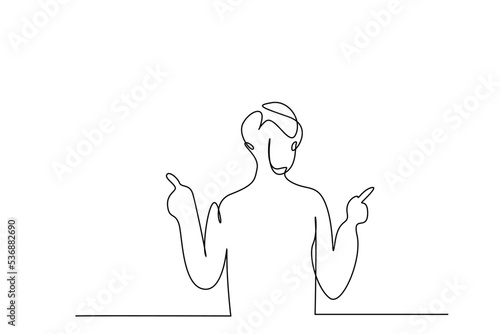a young man shows options with index fingers of both hands