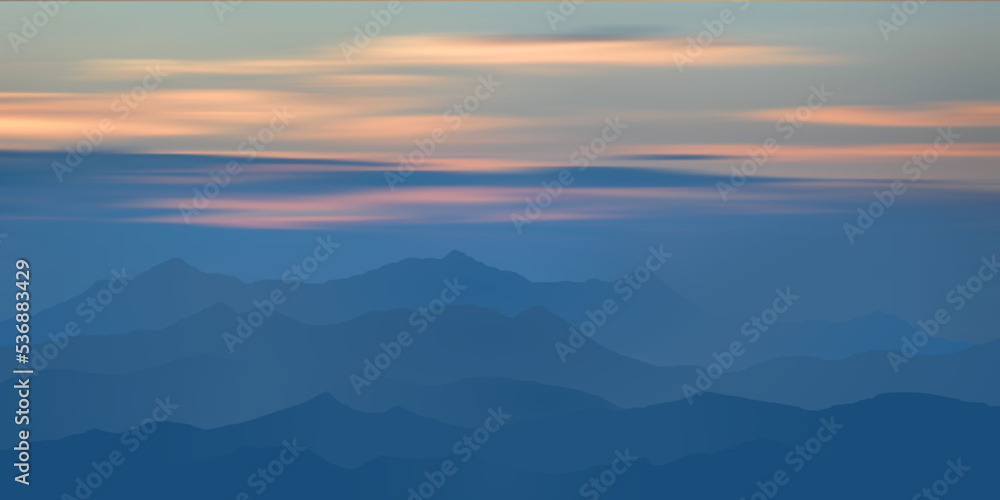 Sunset in the mountains, peaks in the haze, clouds