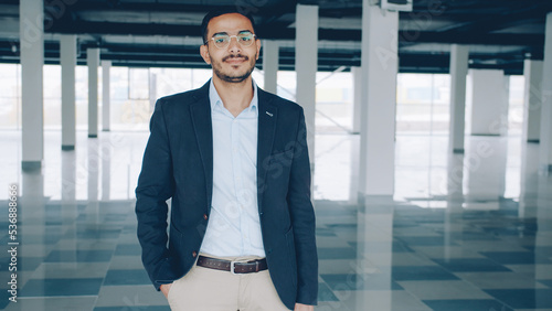 Canvas Print portrait of Arab businessman standing indoors empty industrial building and looking at camera