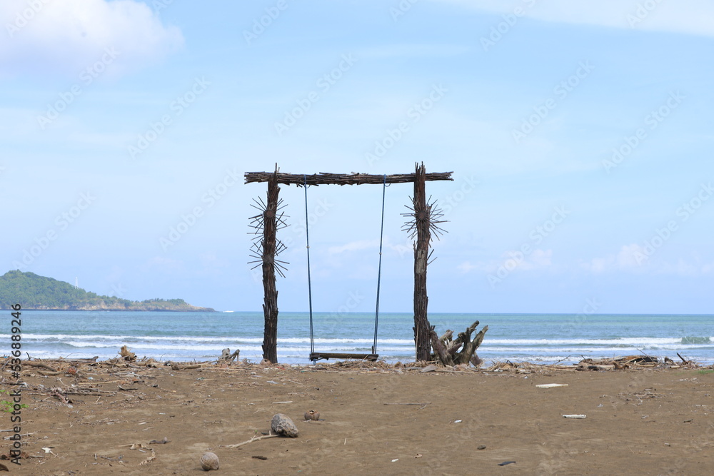 A wooden swing on the shores of Teleng Ria Beach in Pacitan, East Java. Great for nature backgrounds and wallpapers. A wooden swing on the shores of Teleng Ria Beach in Pacitan, East Java. Great for nature backgrounds and wallpapers.