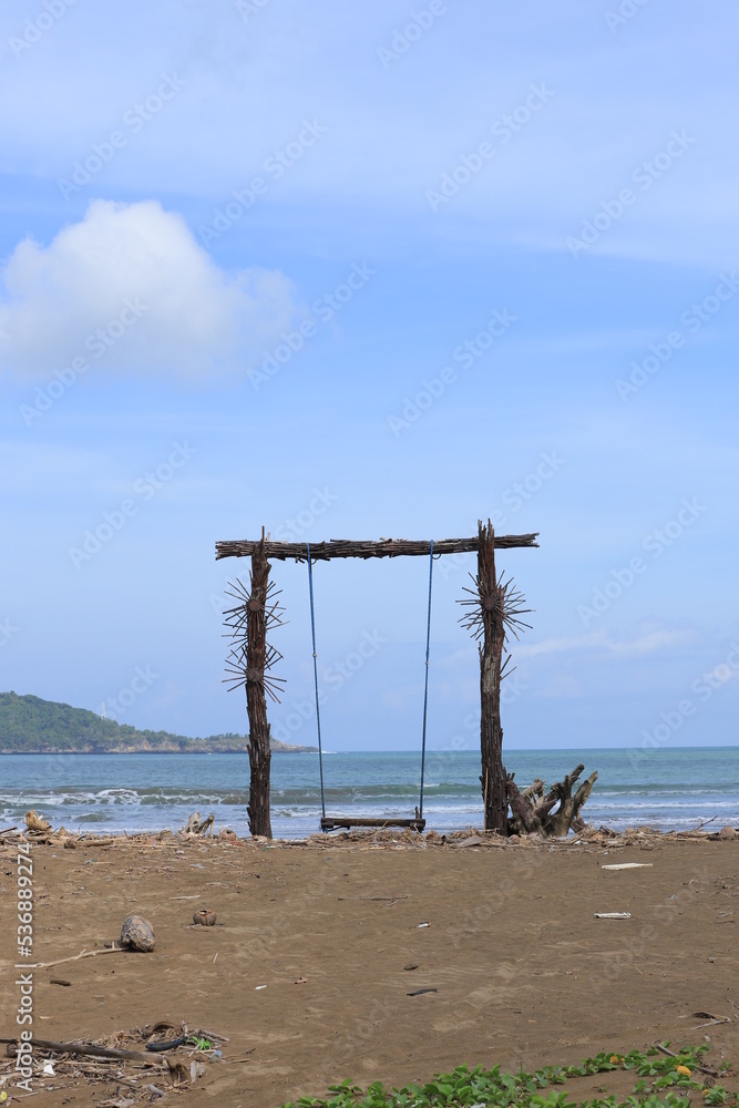 A wooden swing on the shores of Teleng Ria Beach in Pacitan, East Java. Great for nature backgrounds and wallpapers.