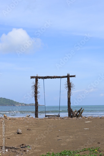 A wooden swing on the shores of Teleng Ria Beach in Pacitan, East Java. Great for nature backgrounds and wallpapers. © uniqephoto