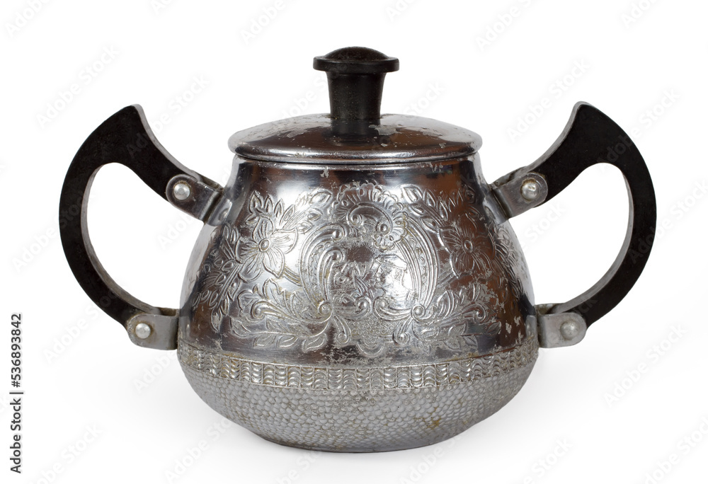 Antique metal sugar bowl with patterns on a white background. Antique metal sugar bowl with patterns on a white background.