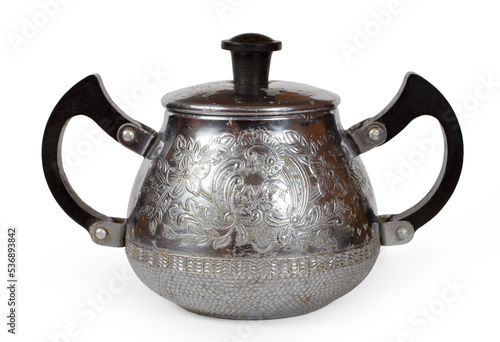 Antique metal sugar bowl with patterns on a white background.
