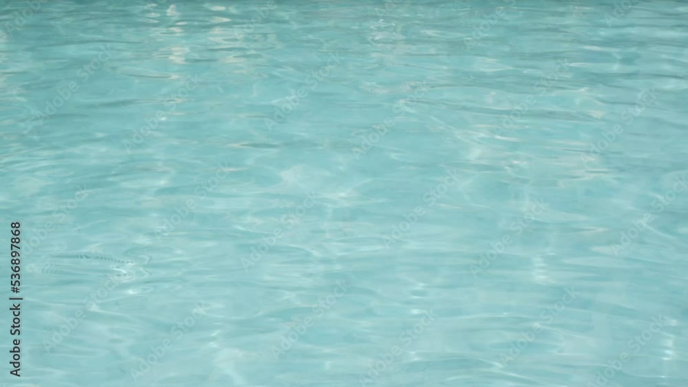 Swimming Pool water surface Reflecting On A Sunny Day, clear water on vacation summer holiday resort background. Swimming Pool water surface Reflecting On A Sunny Day, clear water on vacation summer holiday resort background.