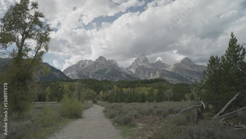 Hiking Taggart Lake Trail, Beautiful Trees and Grand Teton Peaks Towering in Background photo