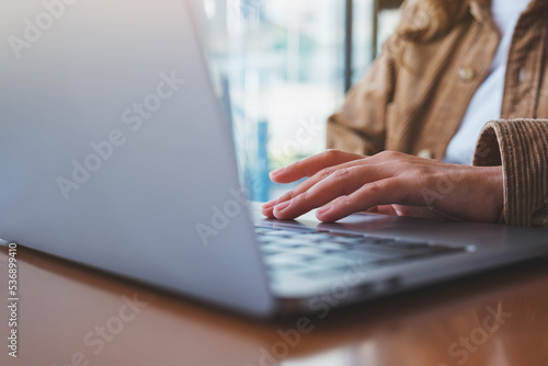 Obraz na plátne Closeup image of a woman working and touching on laptop computer touchpad