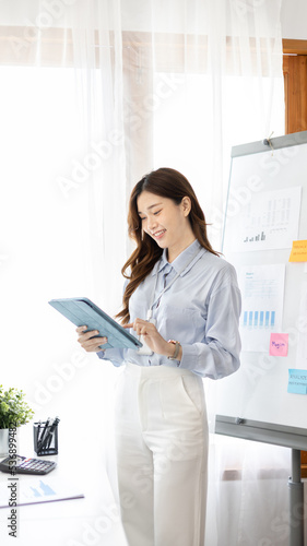 Office worker with a beautiful Asian woman in a private office, Daily routine of office workers, Welcome to work in the morning with a bright smile, Businesswoman in office concept.