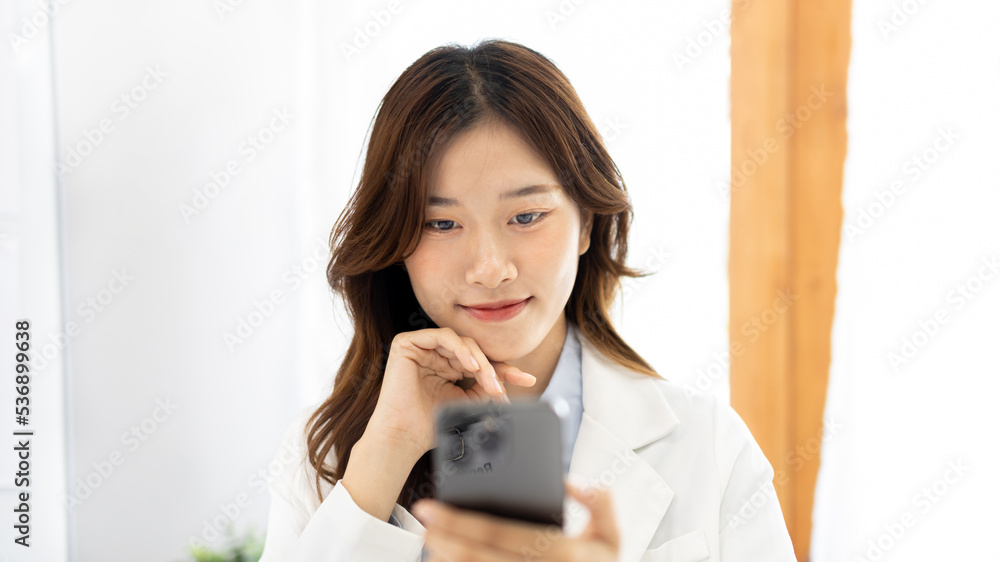 Finance workers are reviewing the company's financial data on a laptop and using smartphones to communicate or chat with the team during  social distances, Talk on the phone or video call.