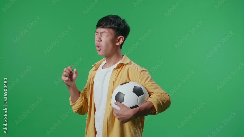 Side View Of Asian Boy With A Ball Is Rooting For Shooting At Goal And Regretting While Cheering Soccer On Green Screen Background
Side View Of Asian Boy With A Ball Is Rooting For Shooting At Goal And Regretting While Cheering Soccer On Green Screen Background