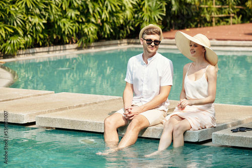 Couple resting near the swimming pool