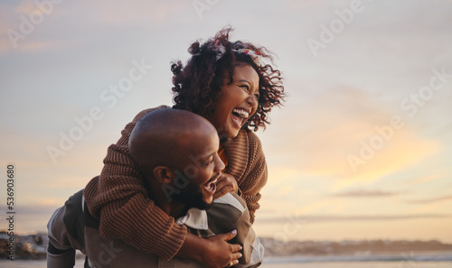 Slika na platnu Black couple, travel and beach fun while laughing on sunset nature adventure and summer vacation or honeymoon with a piggy back ride