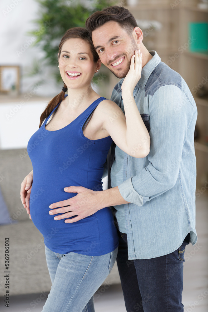 Fototapeta premium portrait of an expectant couple stood in the home
