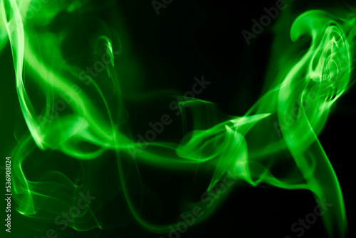 Close-up of green smoke of incense stick against black background with spotlight. Photo taken October 9th, 2022, Zurich, Switzerland.