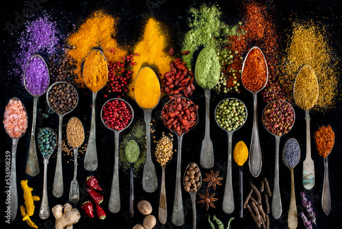 Fototapeta Naklejka Na Ścianę i Meble -  Many various multi colored spices and dried fruits on the table