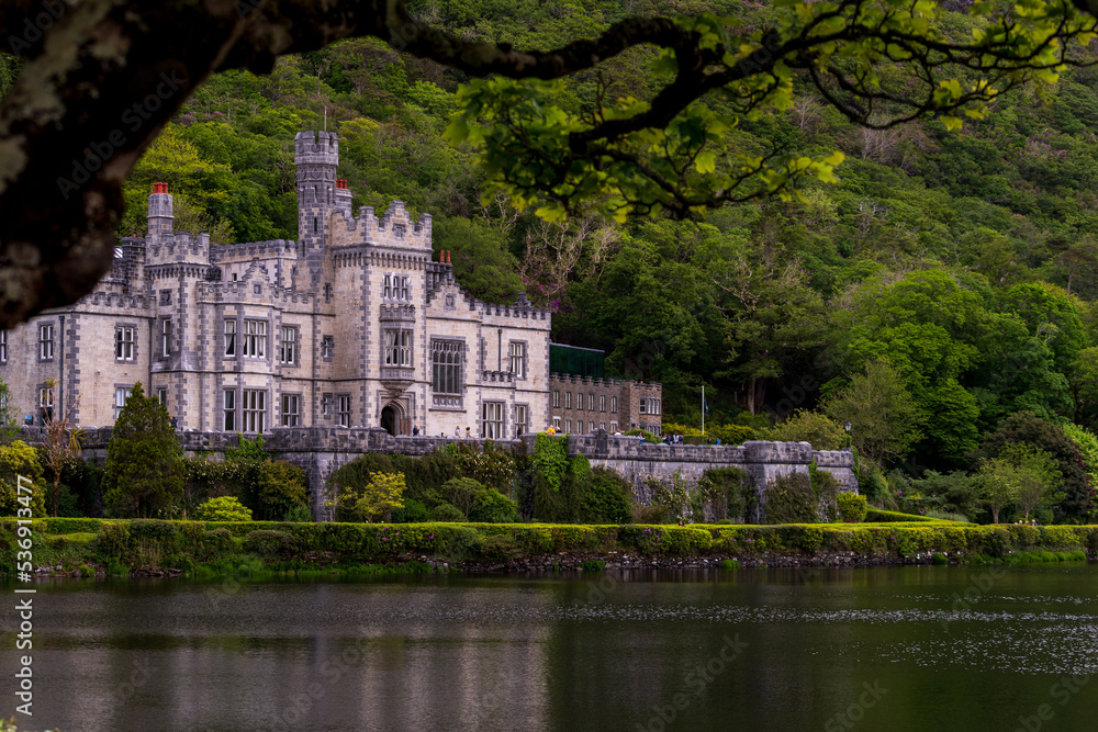Kylemore Abbey,  beautiful castle like abbey reflected in lake at the foot of a mountain. Benedictine monastery founded in 1920, in Connemara, Ireland